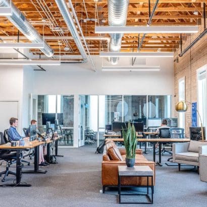 decorators created industrial styled office with exposed ceiling, wood planning and fresh grey carpets