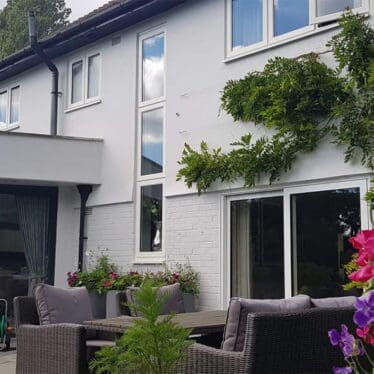 Freshly painted house exterior walls in grey and white