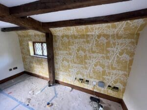 period home interior with freshly installed nature inspired yellow wallpaper
