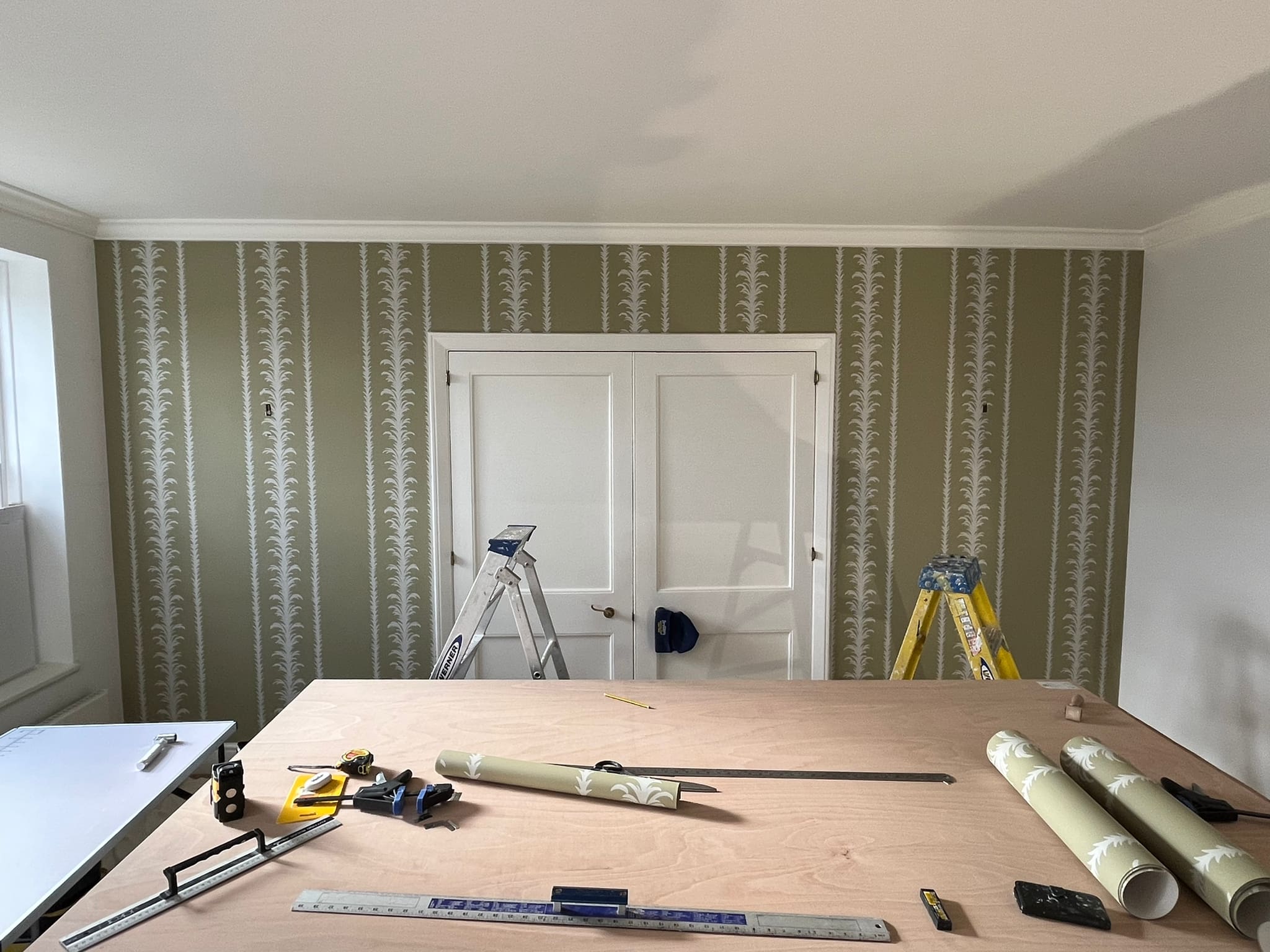 supplies and tools needed to hang wallpaper around a window