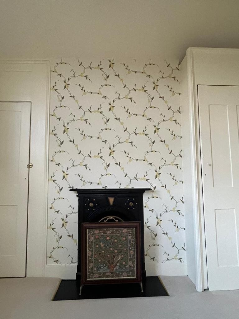 floral accent wallpaper around fireplace