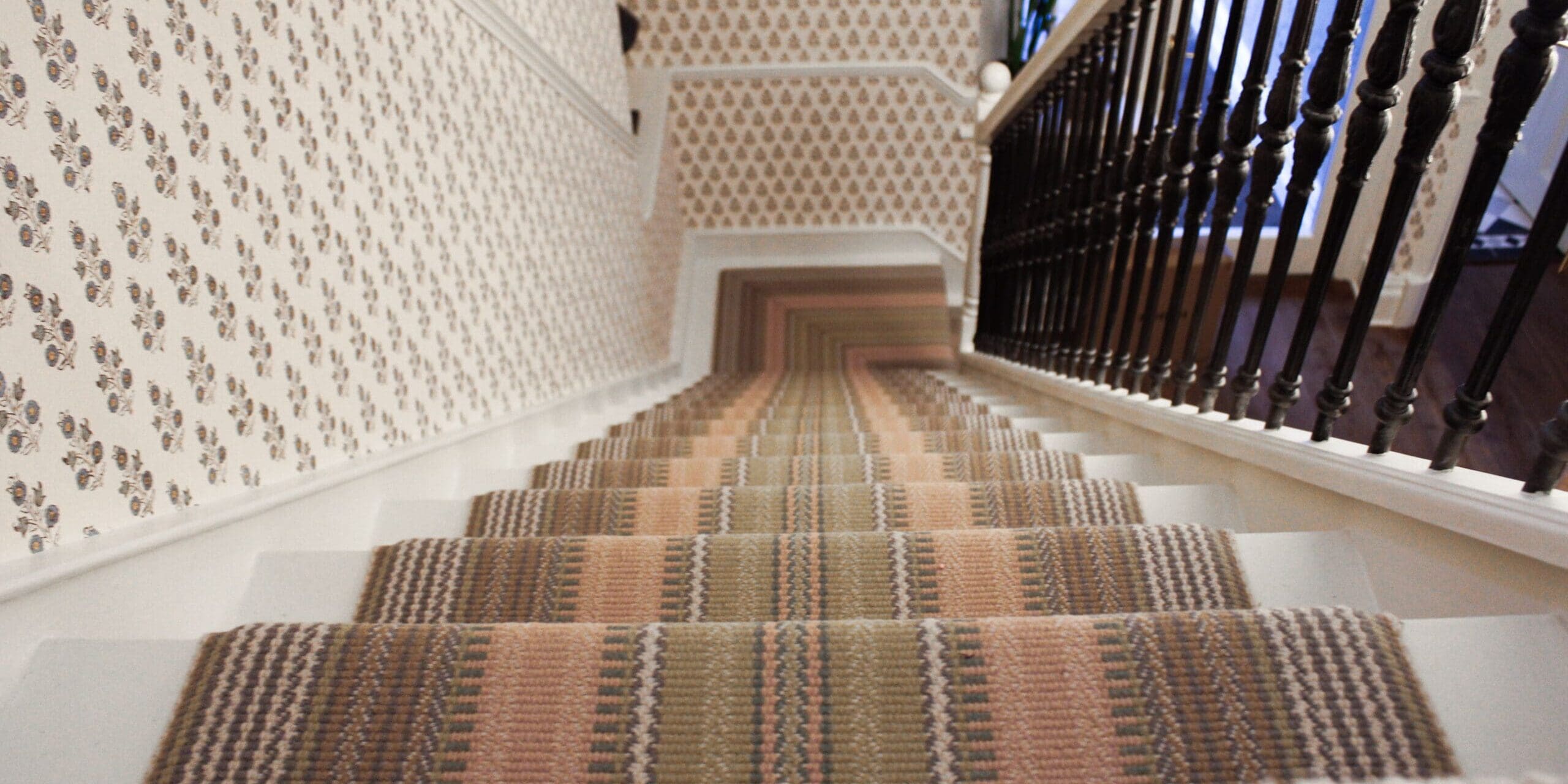 wallpaper in hallway and staircase in surrey home
